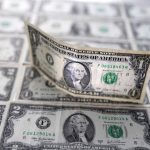 Dollar loses ground against peers after Fed cuts rates