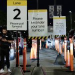 An Uber driver watches his phone while parked in Lot T after the Mets vs. Phillies game at Citizens Bank Park in Philadelphia in 2025.